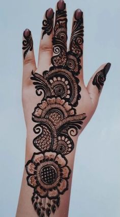 a woman's hand with henna on it