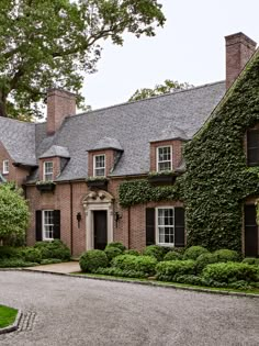 a large brick house covered in ivy