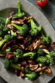 broccoli and mushrooms on a plate with tomatoes