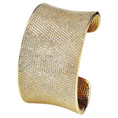 This spectacular micro-set cuff bangle is a guaranteed show stopper. As our signature piece, it represents the collection’s style and uniqueness. Encrusted with over 2,500 of the highest quality brilliant cut cubic zirconia, this statement bangle has been handcrafted to the highest possible standard. Featuring 59 carat of round brilliant cut cubic zirconia hand set in 925 sterling silver with a luxurious 14 karat yellow gold finish. Dimensions 7 inches. Measures 1.5 inches wide. Also available w Long Tassel Necklace, Fire Opal Ring, Tanzanite Gemstone, Diamond Simulant, Princess Cut Diamonds, Cuff Bangles, Semi Precious Gemstones, Karate, Round Brilliant