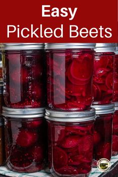 jars filled with pickled beets sitting on top of a shelf