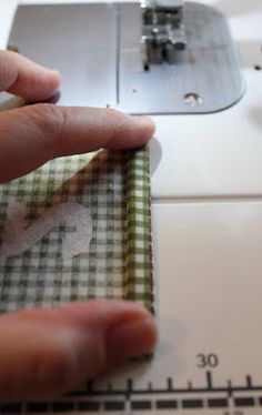 someone is using a sewing machine to sew fabric