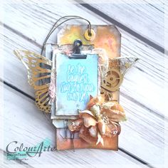 a card with an ornate butterfly and some words on the front, sitting on top of a wooden table