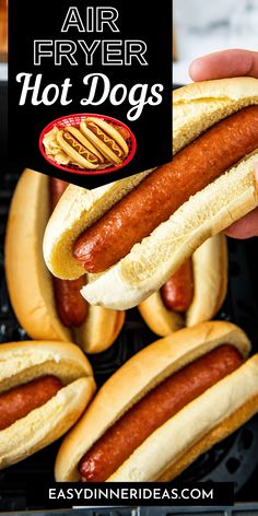 hot dogs with mustard and ketchup on buns in front of an air fryer