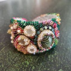 a close up of a bracelet on a table