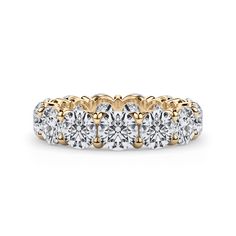 a gold and white diamond ring with four stones on the side, set in 18k yellow gold