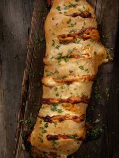 a piece of bread with meat and herbs on it