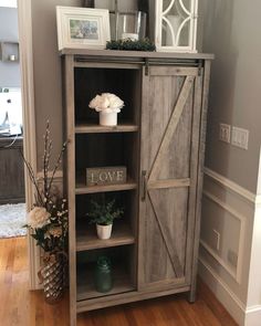 a wooden cabinet with some flowers in it