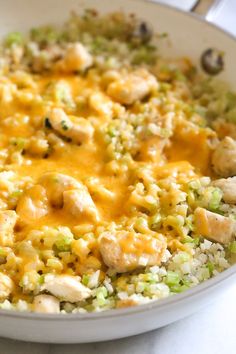 a white bowl filled with rice and chicken