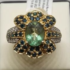 "Vintage 14K Yellow Gold with Quartz? and Diamonds Ring, Size 8.25. Stamped 14K Inside band. Main stone is 9 x 7mm. No missing stones but did see small chips on a couple of the small green stones. Face of ring is 17.5mm wide. Weighs 3.9 dwt. We do not check prongs for wear or stones for looseness. All items are sold as is-noting that we are a resale shop so everything here had a previous owner! We will include flaws in the description when noted. This is one of the reasons our items are more aff Anniversary Green Topaz Ring In Prong Setting, Anniversary Green Topaz Ring With Prong Setting, Green 14k Gold Gemstones For Anniversary, Green Topaz Ring With Accent Stones For Anniversary, Green Topaz Ring With Center Stone For Anniversary, Green Oval Diamond Ring Collectible, Green Diamond Rings Stamped 14k, Gold Emerald Gemstones With Accent Stones, Green Diamond Collectible Ring