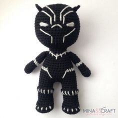 a crocheted black cat stuffed animal on a white background with the words ninjacraft written across it