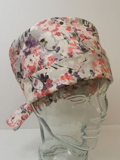 TIE BACK SCRUB HAT ITEM DETAILS.... *Cherry Blossom Floral in Pink, Gray, Lavender *STOCK PHOTO USED.  Due to the nature of handmade items, pattern placement will vary. *COLORS may vary slightly from images shown.   *ONE SIZE.  Features ADJUSTABLE FOLDING BAND and ties to help achieve that perfect, comfortable fit!   *Features covered elastic in the back to keep fabric gathered and neat and also to keep hair covered. *Made from unwashed, 100% premium cotton fabric.   *Machine washable.  Low heat Adjustable Lavender Hat For Spring, Adjustable Lavender Spring Hat, Fitted Bonnet Cap For Spring, Spring Beach Bonnet Fitted, Fitted Beach Bonnet For Spring, Fitted Spring Beach Bonnet, Adjustable Spring Bonnet Cap, Pink Spring Bonnet Cap, Pink Bonnet For Spring