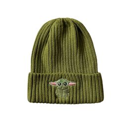 a green knitted hat with a baby yoda face