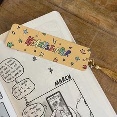 an open book with cartoon characters on it and a keychain attached to the cover