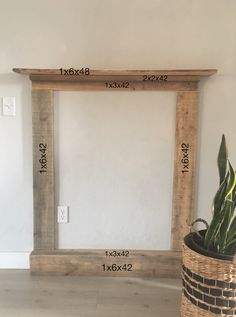 a plant in a basket next to a large wooden frame with measurements for the size