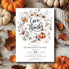 a thanksgiving dinner card with pumpkins and leaves on the table in front of it