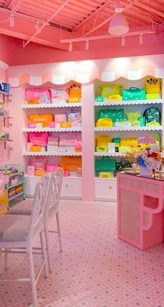 the inside of a children's store with shelves and chairs