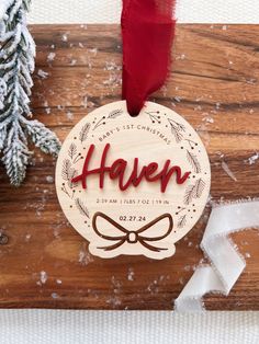 a wooden ornament with the name haven on it and a ribbon hanging from it