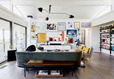 a living room filled with furniture and pictures on the wall