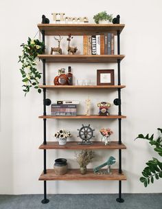 a book shelf with books and plants on it