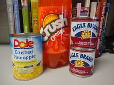 several different types of food and drinks on a counter top with books in the background