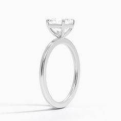 a close up view of a diamond ring on a white background with the center stone missing