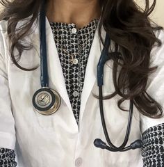 a close up of a person wearing a doctor's coat and stethoscope