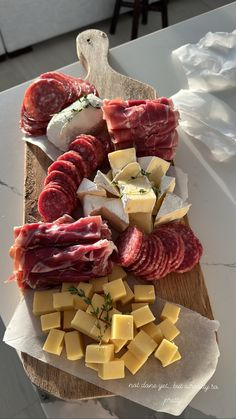 various meats and cheeses on a cutting board