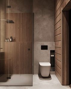 a modern bathroom with wood paneling and white toilet in the shower area, along with a glass door