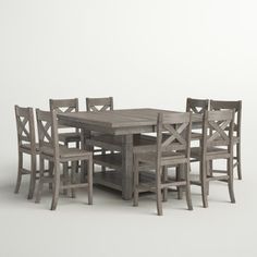 a wooden table and chairs sitting next to each other on a white surface with no one around it