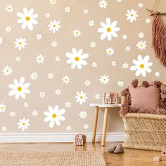 a living room with flowers painted on the wall and wicker furniture in front of it