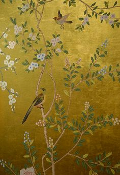 a gold wallpaper with birds and flowers on it