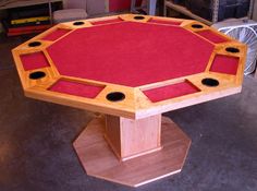 a wooden table with red cloth on it in a room filled with other furniture and tools