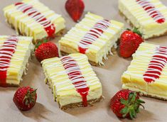 several slices of cheesecake with strawberries on the side