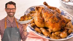 a man standing next to a large chicken on a plate