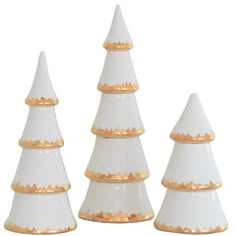 three white and gold decorated christmas trees