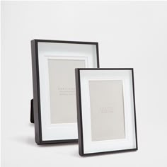 two black and white frames sitting next to each other