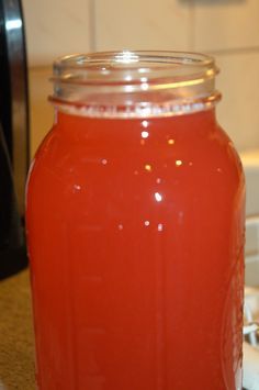 a glass jar filled with liquid sitting on top of a counter