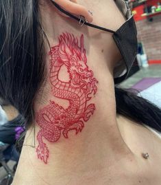 a woman with a dragon tattoo on her neck