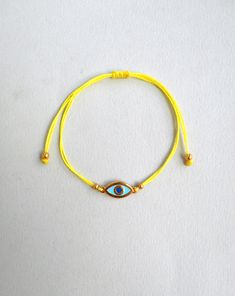 Martis bracelet, Evil eye bracelet Gold enamel charm, Waxed cord March bracelets, Red and White, Twisted string, Greek Tradition Unisex gift The March bracelet is an ancient Greek custom. From the beginning of March, people wear a bracelet made of white and red twisted thread. According to the tradition, the March bracelet protects those from burning of the first sun of spring. The last day of March,the bracelet is left on trees so that swallows can use it for building their nests. Bracelet is m Gold Braided Evil Eye Bracelet As A Gift, Gold Braided Bracelet With Evil Eye For Gift, Gold Braided Bracelet With Evil Eye As Gift, Yellow Adjustable Cord Bracelet, Gold Evil Eye Bracelet With Adjustable Length As Gift, Gold Waxed Cord Friendship Bracelets As Gift, Adjustable Yellow Bracelets As Gift, Adjustable Yellow Bracelets For Gifts, Yellow Braided Bracelet For Gift