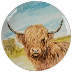 a plate with a painting of a brown cow on it's front and side