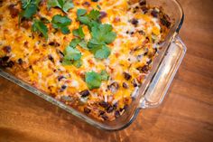 a casserole dish with cheese, black beans and cilantro