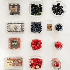 various fruits and vegetables in plastic containers on a table