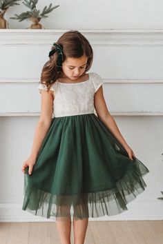 Delicate and beautiful, the Aria dress is timeless and versatile. The layers of flowing tulle feel like a dream and the dainty lace-lined bodice in ecru is picture perfect. Styled for the holidays, Fall photos or any occasion, Aria is a special choice. The green tulle pairs with our Fawn green tulle dress. Green Christmas Outfit, Santa Minis, Green Tulle Dress, Indie Men, Wedding Kids Outfit, Aria Dress, Mini Outfit, Green Tulle, Girls Christmas Outfits