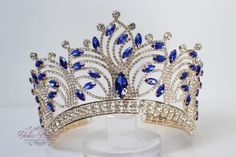 "Beautiful sparkling tiara in gold color with royal blue stones Approx. 4\" tall Perfect for any occasion. It has a loop at the end of each side to attach it in your hair with bobby pins for added security. Ships 1-2 business days." Royal Blue Tiara, Crowns For Quinceanera Blue, Blue And Gold Tiara, Sapphire Wave Tiara, Crown With Blue Jewels, Quinceanera Tiaras, Blue Crown, Gold Tiara, Blue Stone