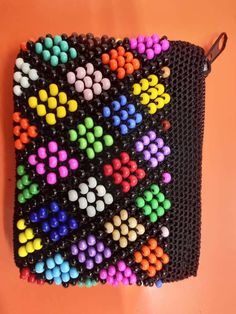 a bag made out of beads on an orange surface