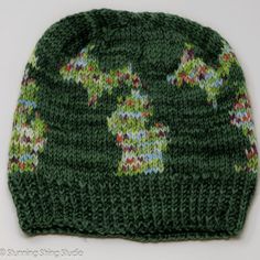 a green knitted hat with two bears on it