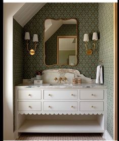 a bathroom with green wallpaper and white vanity