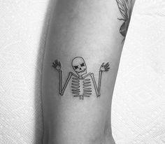 a skeleton tattoo on the leg