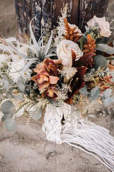 a bridal bouquet sitting on top of a wooden pole